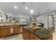 Open kitchen features a large island with granite countertops, a stainless steel dishwasher and adjacent dining at 413 Macchi Ave, Oakland, FL 34787