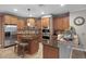 Well-designed kitchen with stainless steel appliances, center island and wood cabinetry at 413 Macchi Ave, Oakland, FL 34787