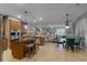 Open-concept kitchen showcases an island with seating, stainless steel appliances and adjacent living area at 413 Macchi Ave, Oakland, FL 34787