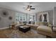 Comfortable living room with a sectional sofa, area rug, and French doors for indoor-outdoor flow at 413 Macchi Ave, Oakland, FL 34787