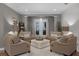 Inviting living space featuring cozy seating arrangements and natural light from the rear doors at 413 Macchi Ave, Oakland, FL 34787