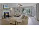 Inviting living room with a fireplace, large sectional sofa, and French doors leading to outdoor space at 413 Macchi Ave, Oakland, FL 34787
