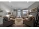 Cozy living room features neutral tones, wood floors and four comfortable armchairs for gathering at 413 Macchi Ave, Oakland, FL 34787