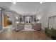 Comfortable living room with four plush armchairs, an ottoman, and double doors leading to the outside at 413 Macchi Ave, Oakland, FL 34787