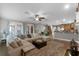 Open living space with sectional sofa, dining area, and kitchen, ideal for entertaining at 413 Macchi Ave, Oakland, FL 34787