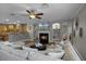 Open-concept living space with a cozy fireplace, modern furnishings, and access to the kitchen at 413 Macchi Ave, Oakland, FL 34787