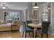 Open-concept living space with a cozy seating area, dining nook, and light-filled shuttered windows at 413 Macchi Ave, Oakland, FL 34787