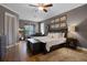 Relaxing main bedroom with a cozy chaise lounge, dark wood accents, and plenty of natural light at 413 Macchi Ave, Oakland, FL 34787