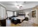 Comfortable main bedroom with a plush bed, chaise lounge, and ample natural light at 413 Macchi Ave, Oakland, FL 34787