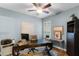 Bright office features a ceiling fan, built-in shelving, and a large desk for productivity at 413 Macchi Ave, Oakland, FL 34787