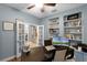 A professional office features French doors, built-in shelves, and a workstation at 413 Macchi Ave, Oakland, FL 34787