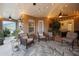 Inviting covered patio with comfortable seating, decorative rug, and string lights for a cozy ambiance at 413 Macchi Ave, Oakland, FL 34787