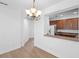Dining area view into modern kitchen with hardwood floors at 456 Harbor Winds Ct, Winter Springs, FL 32708