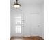 Bright entryway features a glass-paneled front door, hardwood floors, and a modern light fixture at 456 Harbor Winds Ct, Winter Springs, FL 32708