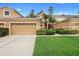 Charming two-story home with well-maintained lawn and landscaping features a large two-car garage at 456 Harbor Winds Ct, Winter Springs, FL 32708