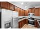 Well-equipped kitchen with stainless steel appliances and wood cabinetry at 456 Harbor Winds Ct, Winter Springs, FL 32708