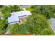 Birds eye view of the home with mature tree coverage, roof access, and a paved patio at 511 S Alder Ave, Orlando, FL 32807