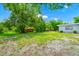 Expansive backyard featuring lush greenery, mature trees, and a well-maintained lawn at 511 S Alder Ave, Orlando, FL 32807