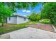 Backyard with a brick paved patio, a green lawn, and a fence, creating a private outdoor space at 511 S Alder Ave, Orlando, FL 32807