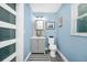 Stylish half-bathroom with a modern vanity, sleek fixtures, and a coastal-inspired decor, providing a refreshing space at 511 S Alder Ave, Orlando, FL 32807