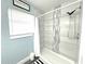 Updated bathroom showcasing modern shower, stylish tile accents, and contemporary fixtures at 511 S Alder Ave, Orlando, FL 32807
