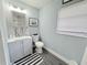 Bathroom with modern vanity, light blue walls, and gray wood floor at 511 S Alder Ave, Orlando, FL 32807