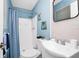 Stylish bathroom with blue accents, shower with curtain, modern sink, and nautical decor at 511 S Alder Ave, Orlando, FL 32807