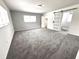 Spacious bedroom with neutral carpet and a modern sliding barn door leading to other rooms at 511 S Alder Ave, Orlando, FL 32807
