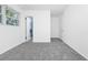 Bright bedroom with gray carpet, white walls, and access to bathroom and closet at 511 S Alder Ave, Orlando, FL 32807