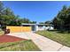 Charming single-story home with a well-maintained lawn, fenced yard, and a long driveway leading to the entrance at 511 S Alder Ave, Orlando, FL 32807