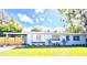 Charming single-story home featuring a spacious yard, carport, and neatly manicured landscaping at 511 S Alder Ave, Orlando, FL 32807
