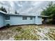 Exterior of the home with light blue siding and a chain-link fence at 511 S Alder Ave, Orlando, FL 32807