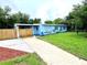 Charming single-story home with a well-maintained lawn, fenced yard, and a long driveway leading to the entrance at 511 S Alder Ave, Orlando, FL 32807