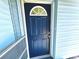 This property boasts a navy blue front door with half moon window and matching screen door at 511 S Alder Ave, Orlando, FL 32807
