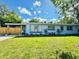 Charming blue home with a well-manicured lawn and a gated entrance at 511 S Alder Ave, Orlando, FL 32807