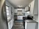 Bright eat-in kitchen with white cabinets, stainless steel appliances, and granite countertops at 511 S Alder Ave, Orlando, FL 32807