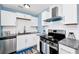 Bright kitchen featuring stainless steel appliances, white cabinets, and stylish countertops for a modern culinary experience at 511 S Alder Ave, Orlando, FL 32807
