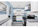 Modern kitchen with white cabinets, granite countertops, and stainless steel appliances for a sleek and stylish look at 511 S Alder Ave, Orlando, FL 32807