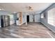 Open-concept living area with gray flooring, neutral walls, ceiling fan, and ample natural light creating a warm atmosphere at 511 S Alder Ave, Orlando, FL 32807