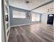 Bright and airy living space featuring a modern barn door, and stylish gray floors for a clean, minimalist feel at 511 S Alder Ave, Orlando, FL 32807