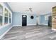 Spacious living room with large windows, modern ceiling fan, and stylish gray flooring at 511 S Alder Ave, Orlando, FL 32807
