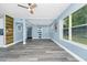 Open living room with sliding barn door, large windows, and stylish gray flooring at 511 S Alder Ave, Orlando, FL 32807