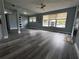 Inviting living room featuring abundant natural light, and stylish gray flooring, creating a comfortable and welcoming space at 511 S Alder Ave, Orlando, FL 32807