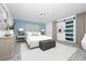 Serene main bedroom with neutral tones, ample natural light, and sliding glass door for a peaceful retreat at 511 S Alder Ave, Orlando, FL 32807