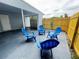 This home has a comfortable outdoor area with modern blue patio chairs and a privacy fence at 511 S Alder Ave, Orlando, FL 32807
