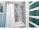 Modern walk-in shower featuring stylish tile work, sleek fixtures, and a glass door for a luxurious bathing experience at 511 S Alder Ave, Orlando, FL 32807