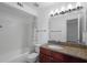Well-lit bathroom featuring a granite countertop vanity and shower-tub combo at 5156 Conroy Rd # 1124, Orlando, FL 32811