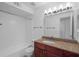 Bathroom featuring a granite countertop vanity, ample lighting, and shower-tub combo at 5156 Conroy Rd # 1124, Orlando, FL 32811