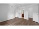 Spacious bedroom with wood-look floors, neutral walls, and an ensuite bathroom at 5156 Conroy Rd # 1124, Orlando, FL 32811