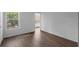 Bright bedroom featuring wood-look floors and a large window overlooking the neighborhood at 5156 Conroy Rd # 1124, Orlando, FL 32811